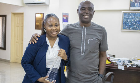 UPSA law lecturer, Yorm Abledu, presents her 2022 IBA Outstanding Young Lawyer award to Vice-Chancellor